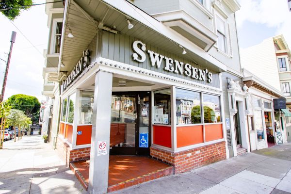 Swensen’s ice cream shop with large windows on a street corner and a wheelchair accessible entrance.