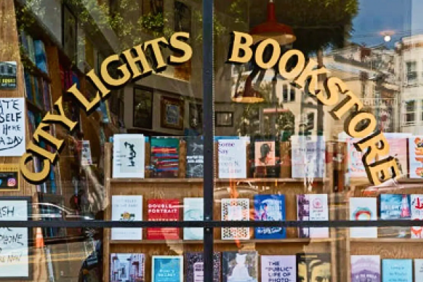 City Lights Bookstore window display with books and a "READ THEM ALL" sign visible inside.