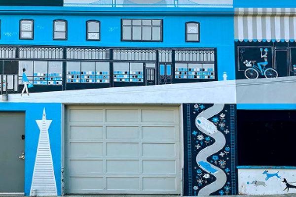Blue mural with buildings, a bicyclist, a pedestrian, geometric patterns, and two dogs playing near a garage door.