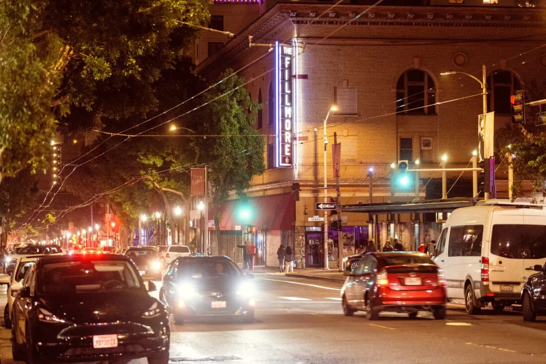 Nighttime street scene with glowing signs in Western Addition San Francisco.